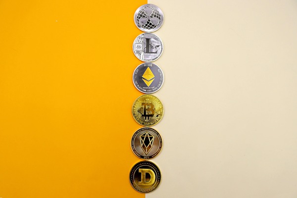 Row of six different cryptocurrency coins including Ethereum, Bitcoin, Ripple and Litecoin