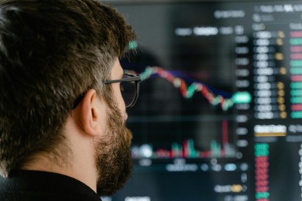 Close-up of a person viewing a cryptocurrency trading chart on a dark screen