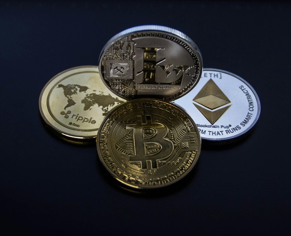 Collection of Bitcoin, Ethereum and Ripple cryptocurrency coins on a dark background