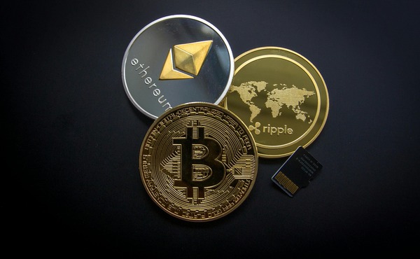 Ethereum, Bitcoin and Ripple cryptocurrency coins on a dark background